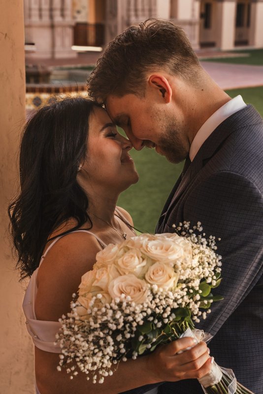 Forehead to forehead at City Hall, Tucson — bouquet in hand